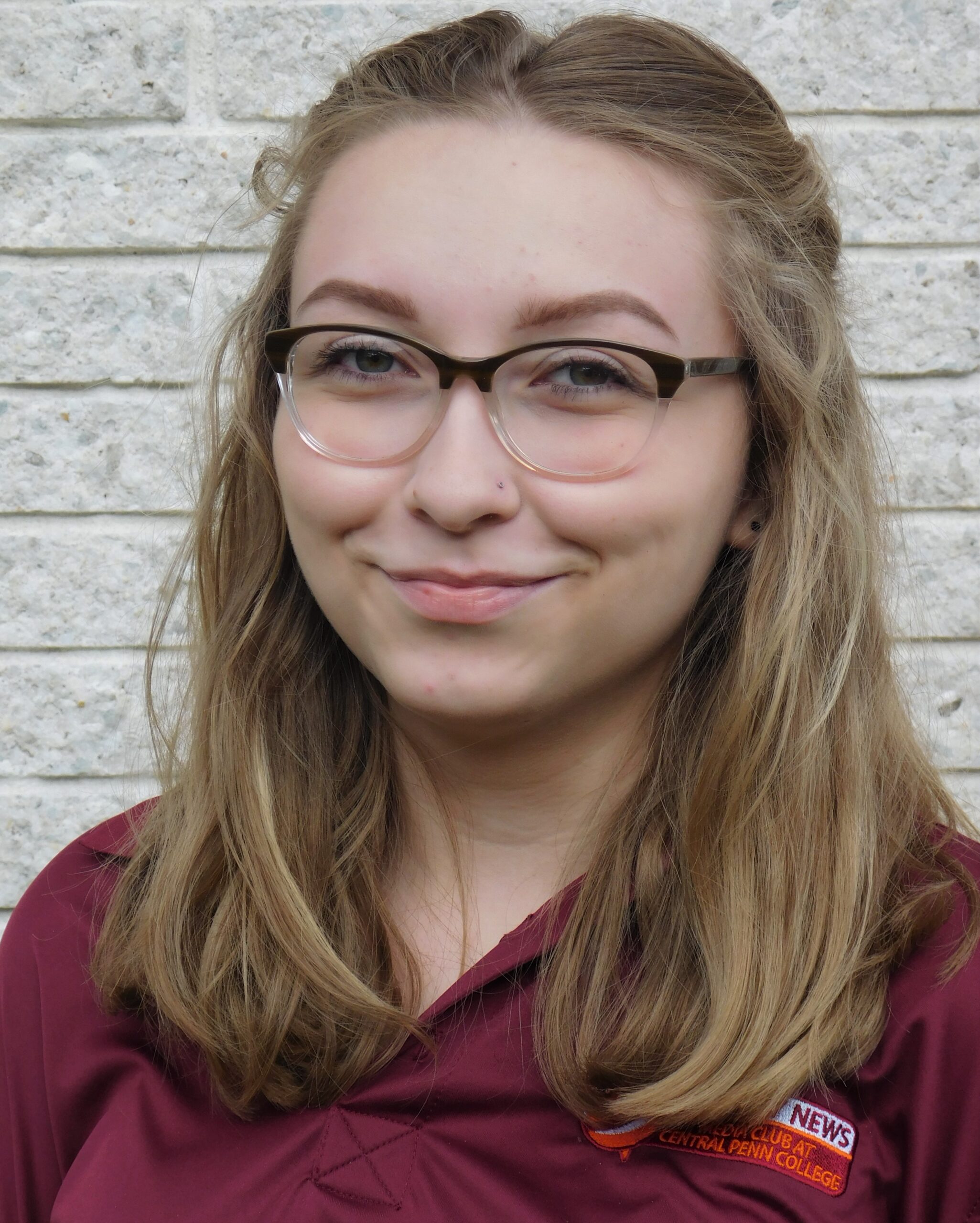 Young blond woman with glasses smiling