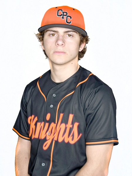 Young man in baseball uniform, black jersey with orange "Knights" in script and and orange low neck and short sleeve-shirt trim, with black baseball cap with orange on the brim edge and an orange and maroon knight logo on the front, middle.