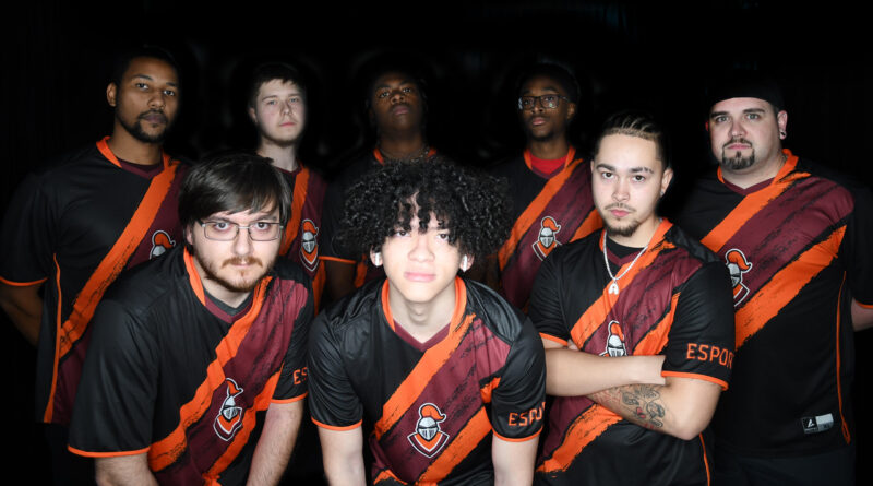 Eight men with black-and-orange jerseys