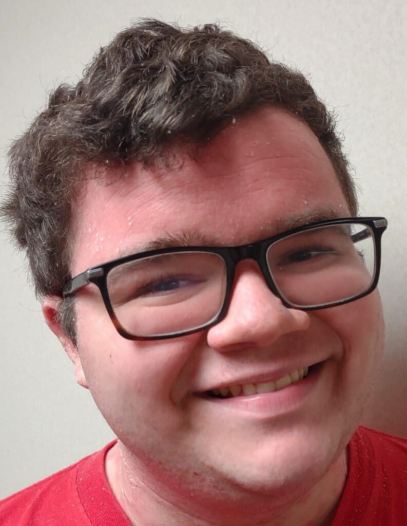 Closeup of smiling young man with glasses