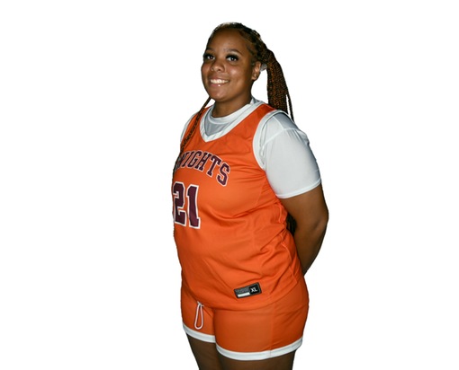 Young woman with braided ponytail in an orange-on-black basketball uniform with Knights and No. 21 on the front of the jersey.