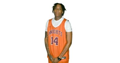 Young woman in an orange-on-white basketball uniform with Knights and No. 14 on the jersey front