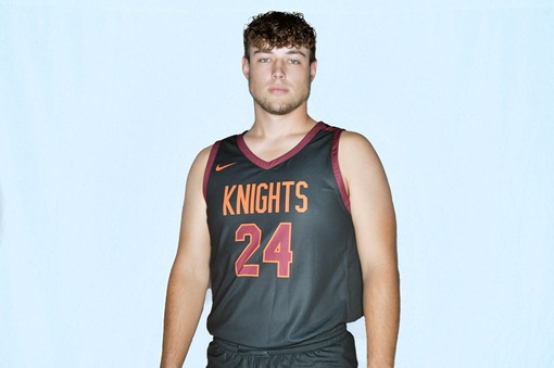 Young man with orange-on-black basketball uniform and Knights and the number 24 on the jersey front in orange with white outline.