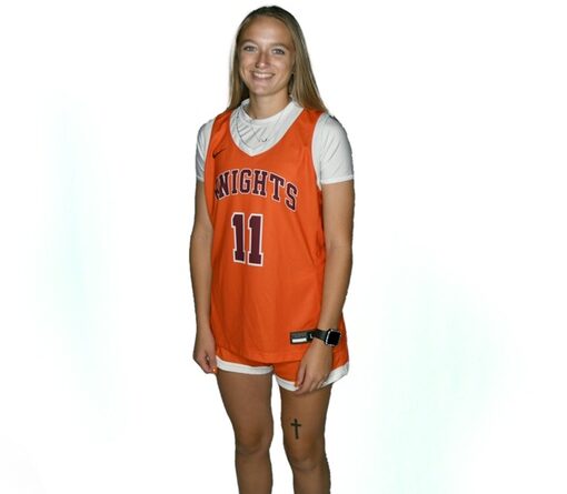Smiling young woman with long blond hair in an orange-on-white basketball uniform with Knights and No. 11 on the front of the jersey