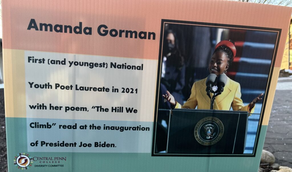U.S. Youth Poet Laureate Amanda Gorman, in a yellow outfit and red hat, reading at President Joe Biden's inauguration in January 2021.
