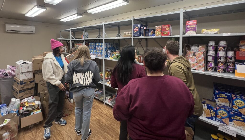 College students in a stock room used as a food pantry.