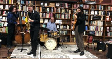 Photo of four musicians on a low stage performing at The Midtown Scholar during Harrisburg's 3rd in the Burg