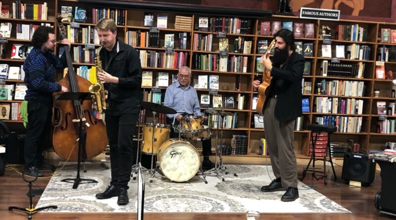 Photo of four musicians on a low stage performing at The Midtown Scholar during Harrisburg's 3rd in the Burg
