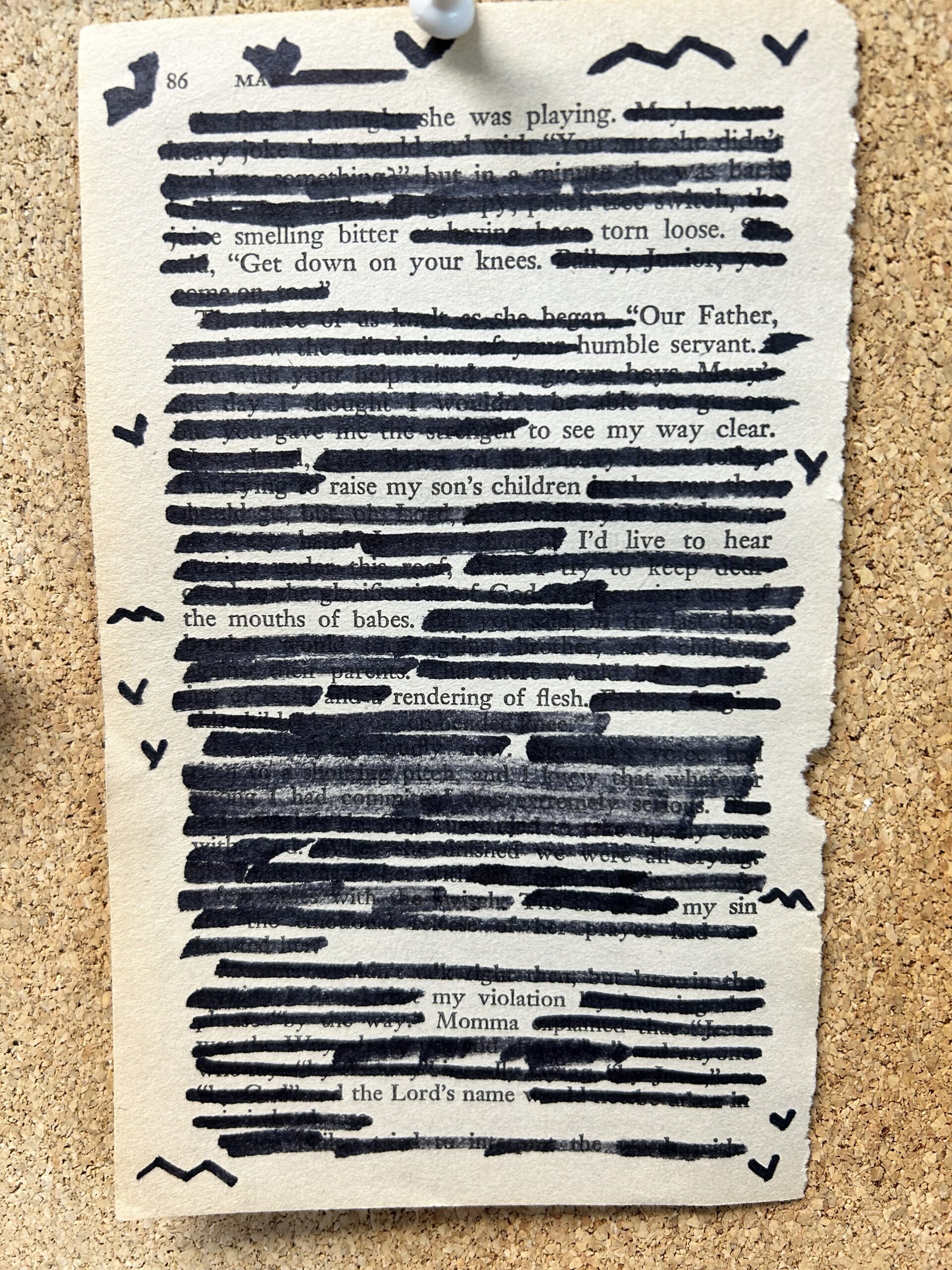A paperback book page with some words on it but with most words blacked out with magic marker