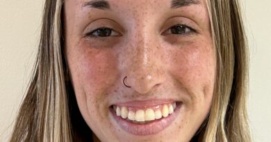 Smiling young blonde woman with freckle. Hannah Pasquarella