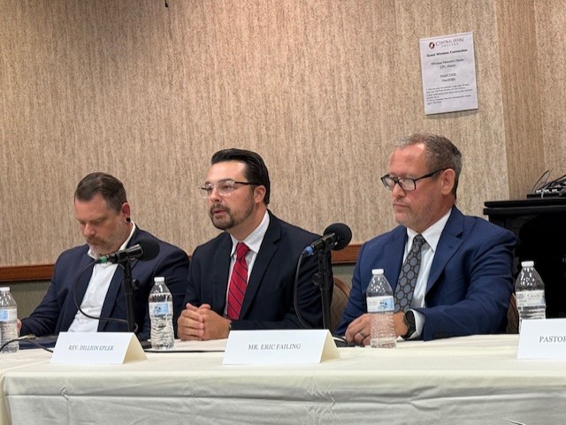 From left, Dauphin County Commissioner Justin Douglas wearing short light-brown hair and a sparse mostly gray beard and a white dress shirt with no tie under a dark-blue blazer; The Rev. Dillon Epler, pastor of St. John's Evangelical Lutheran Church, Tamaqua, with short combed-back black hair, wire glasses, a black jaw-and-chin beard with mustache, and wearing a white dress shirt with a red tie with thin blue diagonal stripes under a black suit coat; and Eric Failing, executive director of the Pennsylvania Catholic Conference, with short light-brown hair with some gray at the front and back, wearing black-framed eyeglasses and a white dress shirt with a maroon-and-gray large-pattern paisley necktie under a navy blue suit coat.