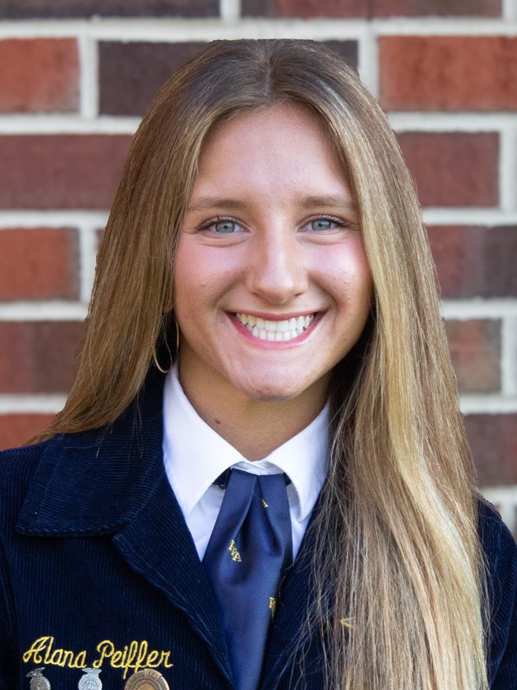 Young woman, smiling, with long blond hair and wearing a high school jacket. Alana Peiffer.
