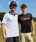 Two young men, one in a black T-shirt and one in a white T-shirt, wearing baseball caps. Central Penn students David Cameron, left, and Blake Eiserman, volunteer with Colleges Against Cancer, at Central Penn College