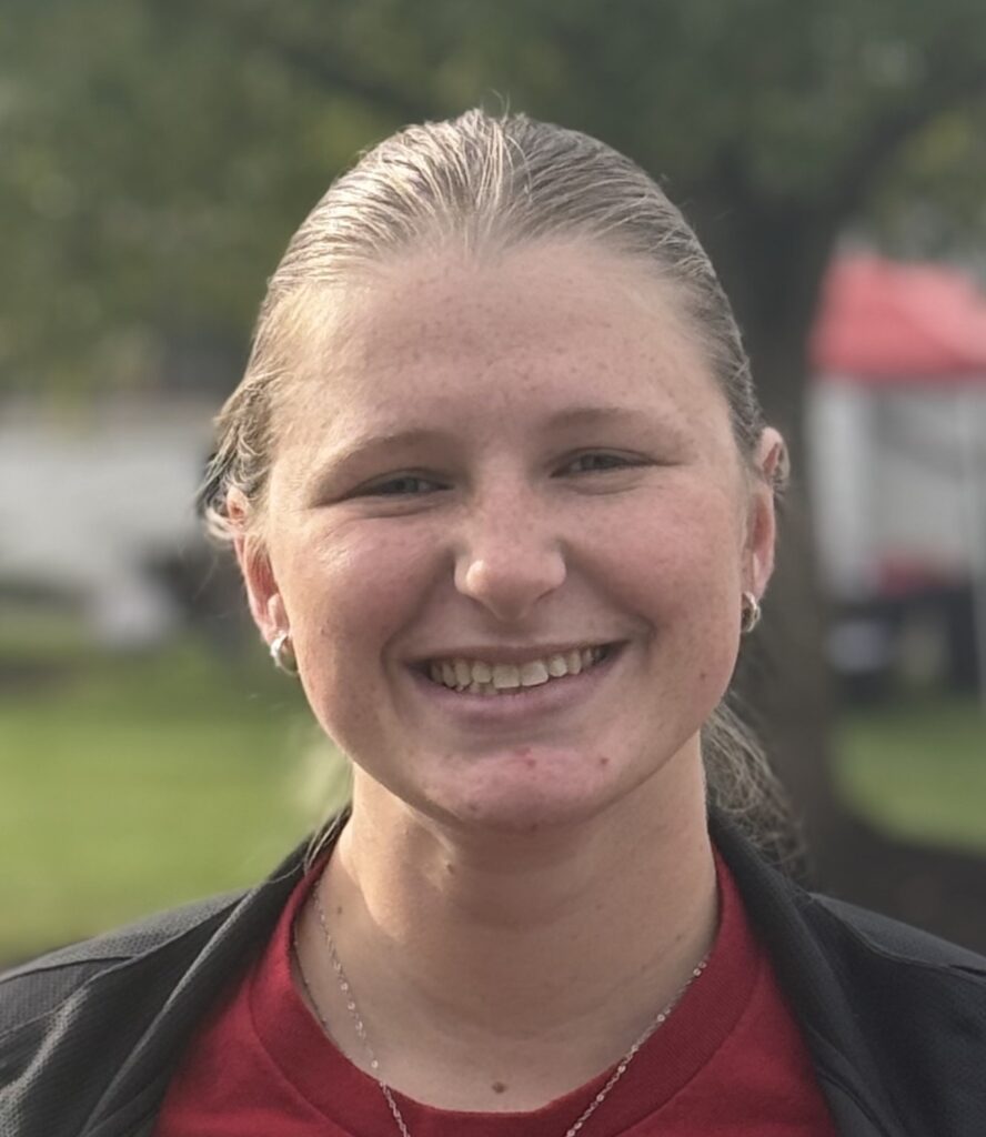 Smiling young woman with tied-back blond hair. Central Penn College Volleyball coach Jessica Dunbar