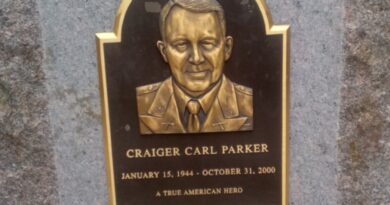 Bronze plaque of Craiger Carl Parker on upright stone.