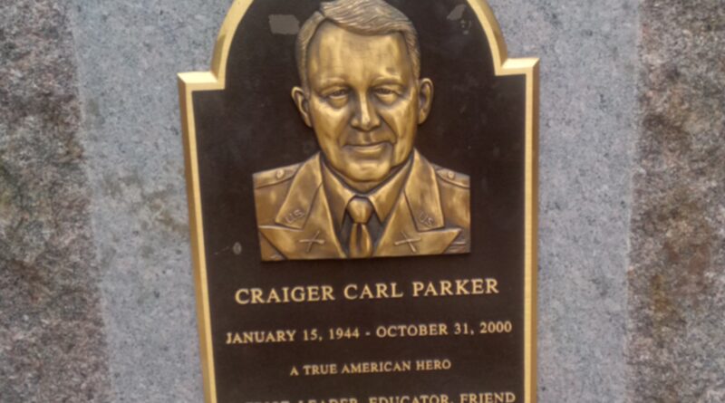Bronze plaque of Craiger Carl Parker on upright stone.