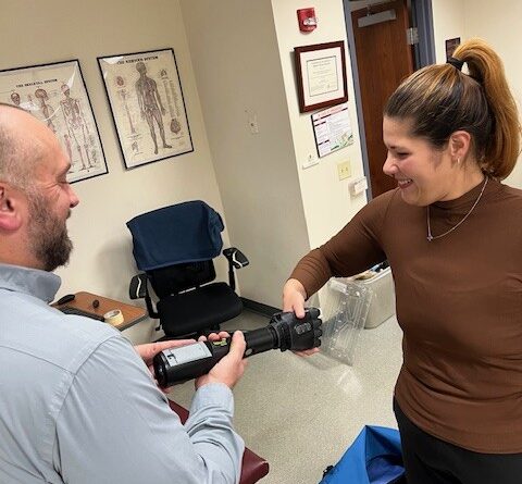Jason Kunec shows a Central Penn student a robotic hand.