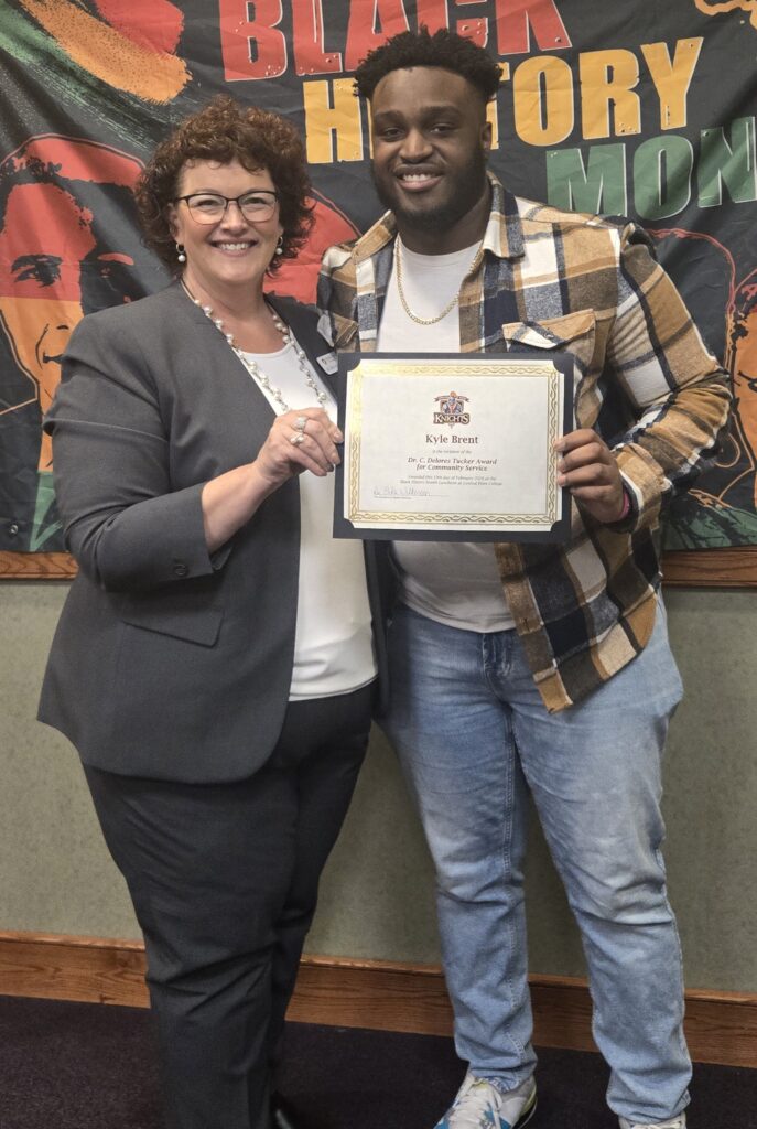 Central Penn College Associate Vice President of Student Services Erika Wilkinson and Central Penn student Kyle Brent standing together and each holding a side of Brent's Dr. C. Delores Tucker Award for Community Service certificate.