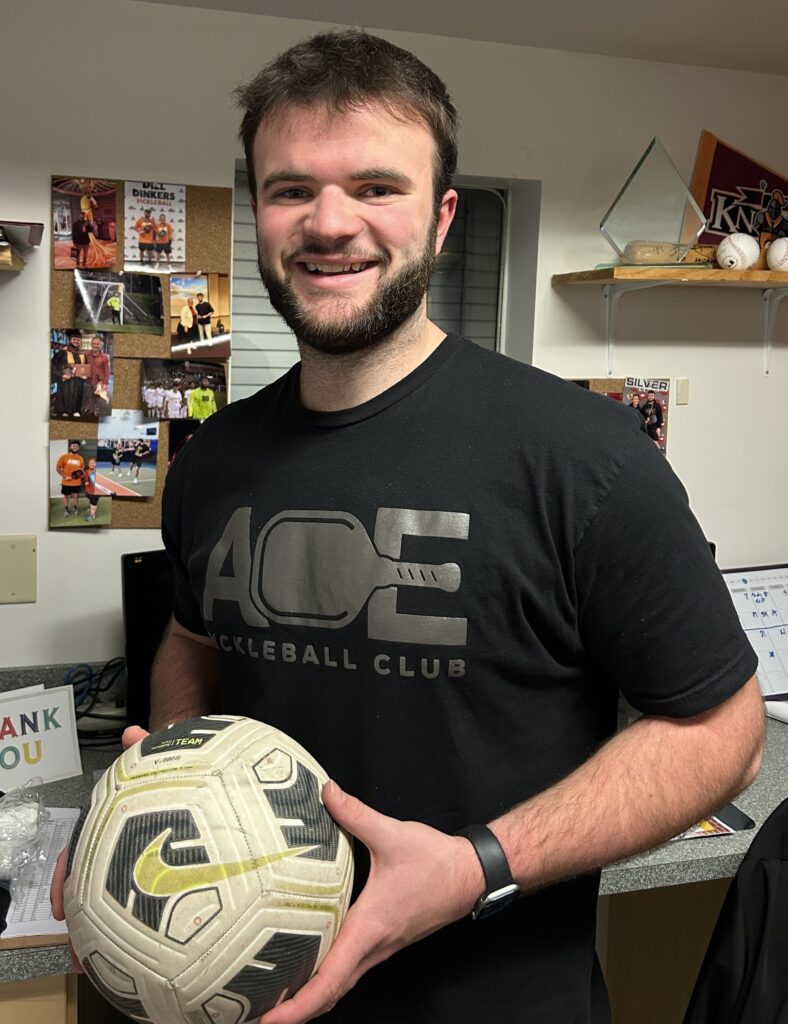 Andrew Hunter holding a soccer ball.