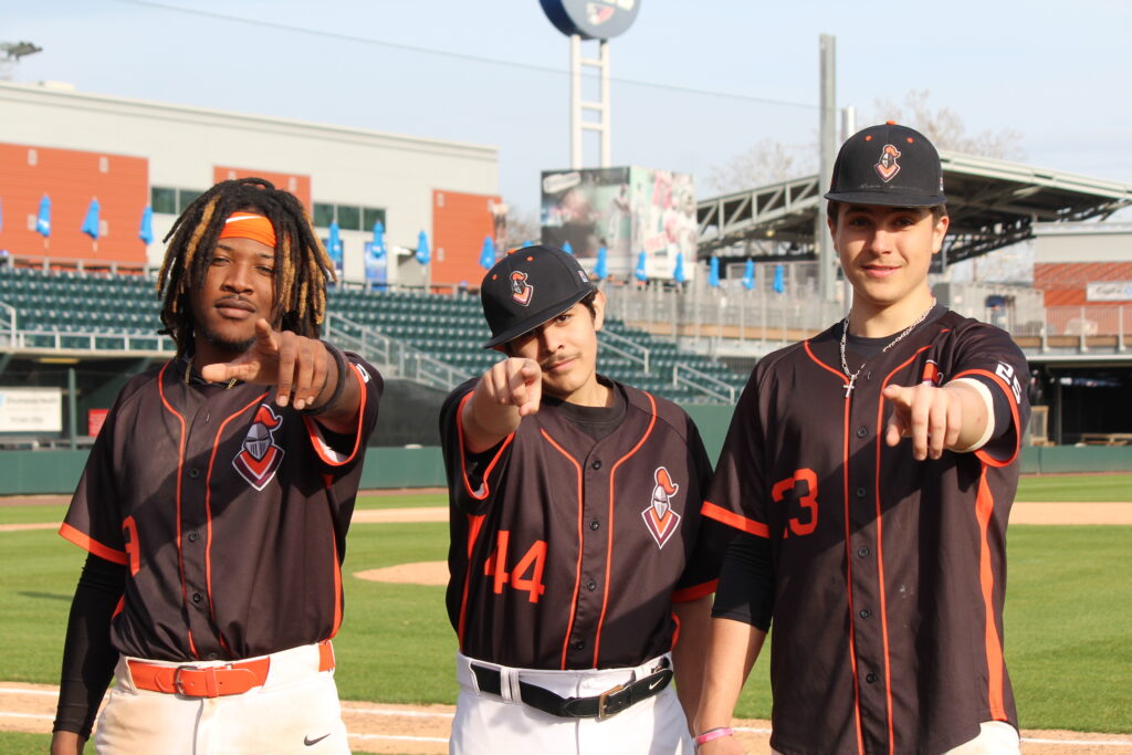 Three Central Penn College baseball players, who are pointing at the camera.