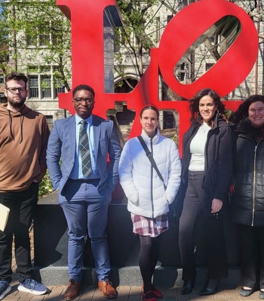 Five people from Central Penn College in front of the Love statue in Center City Philadelphia, where they attended a mock-trial competiton at the University of Pennsylvania and which they helped to jiudge.