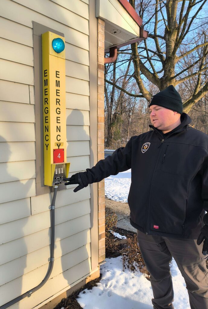Mrakovich shows an emergency call box next to a dorm suite. Photo by Alex Foley
