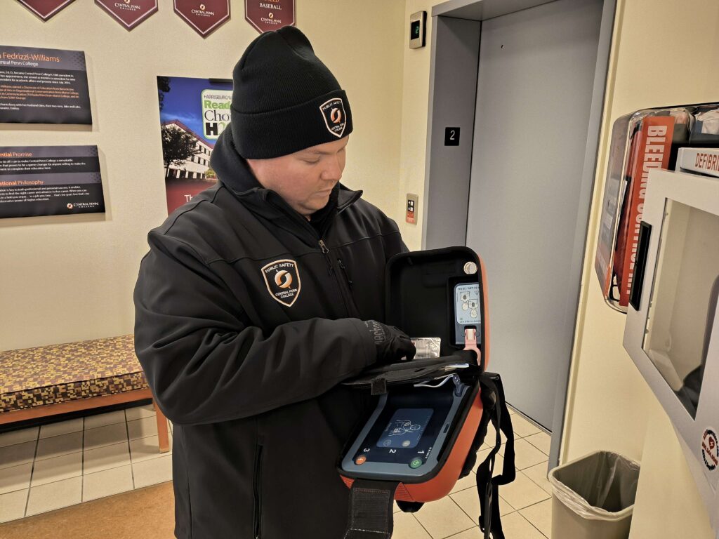 Mrakovich with an AED (an external automated defibrillator). Photo by Alex Foley
