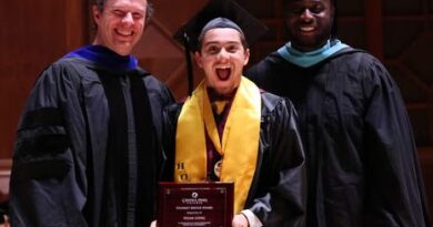 sSudent smiling mouth open, and standing between two men. All of the are wearing academic-graduation regalia. The student is Noah Lopez. The man on the left of the photo is Central Penn College Associate Provost Jared Rife, and the man on the right is Central Penn College Vice President of Student Services Romeo Azondekon. 2026 Central Penn graduation, at The Forum, in Harrisburg, Pennsylvania.